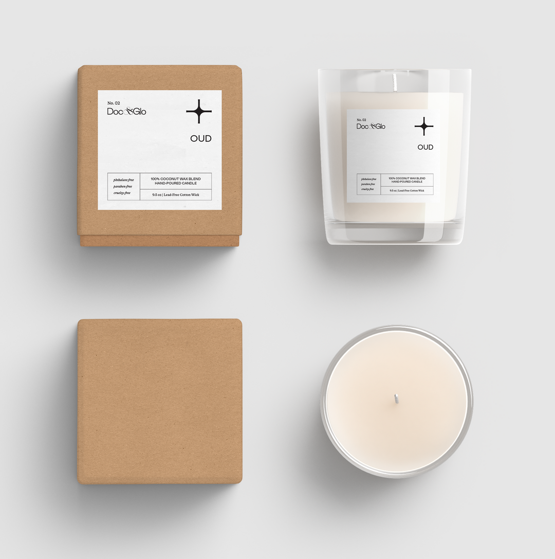 Candle and packaging with 'Doc & Glo' branding on a light gray background