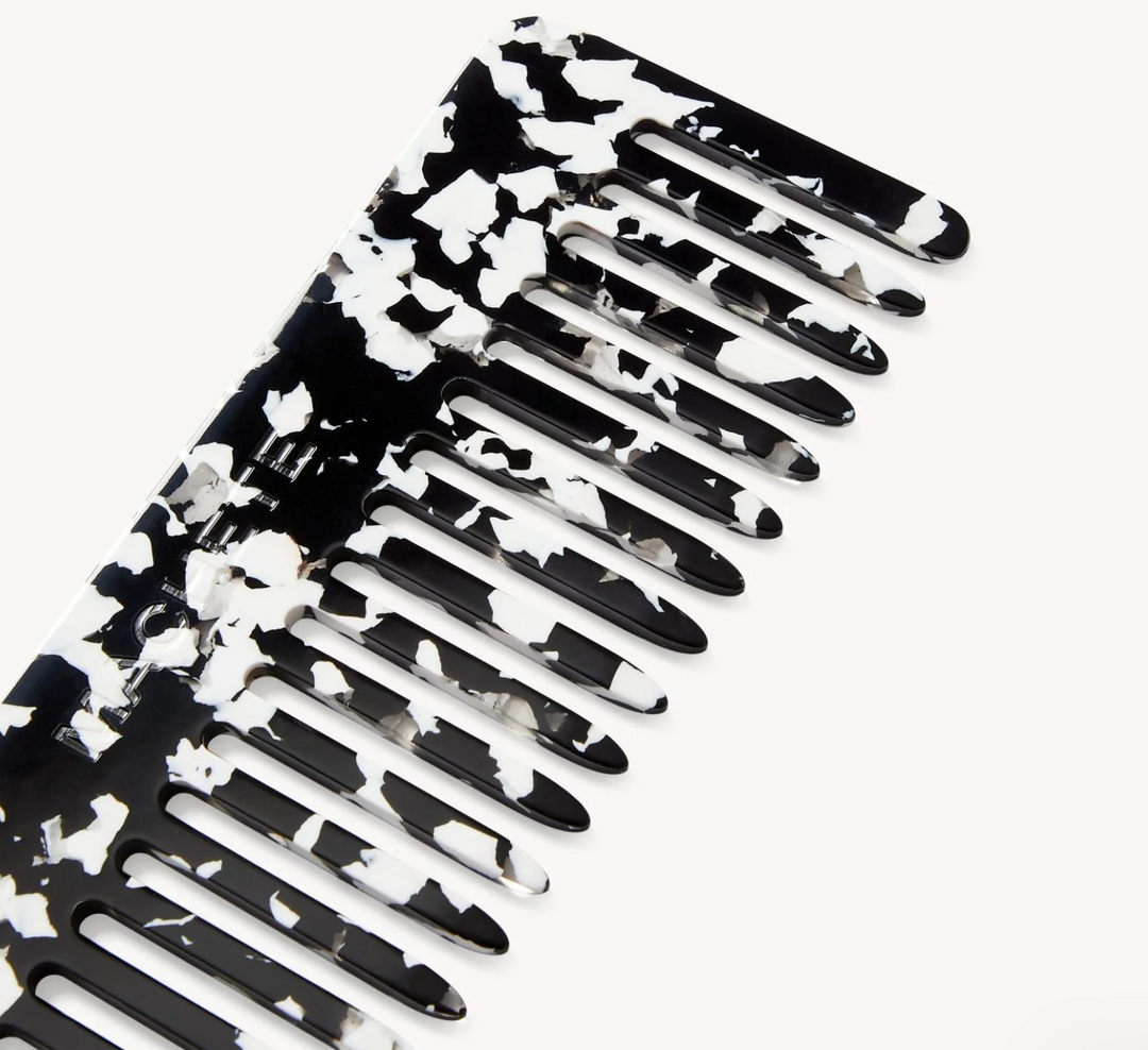 Black and white floral-patterned comb on a white background