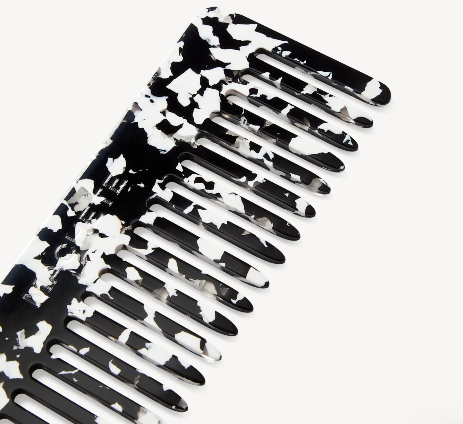 Black and white floral-patterned comb on a white background