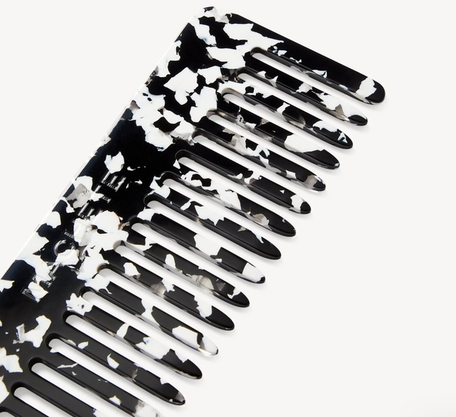Black and white floral-patterned comb on a white background