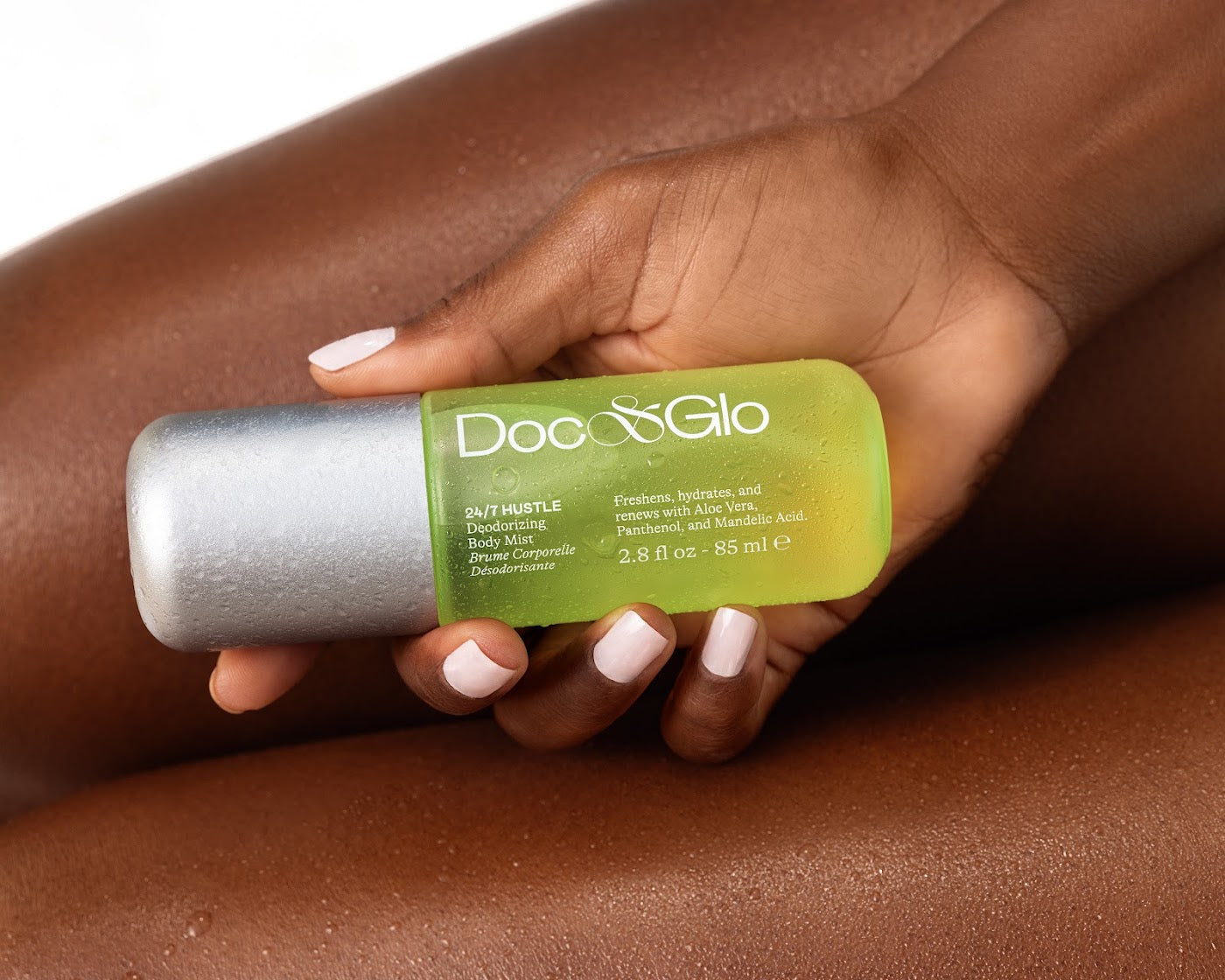 Hand holding the 24/7 Hustle Deodorizing Body Mist